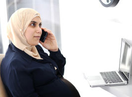 pregnant woman at work on the phone